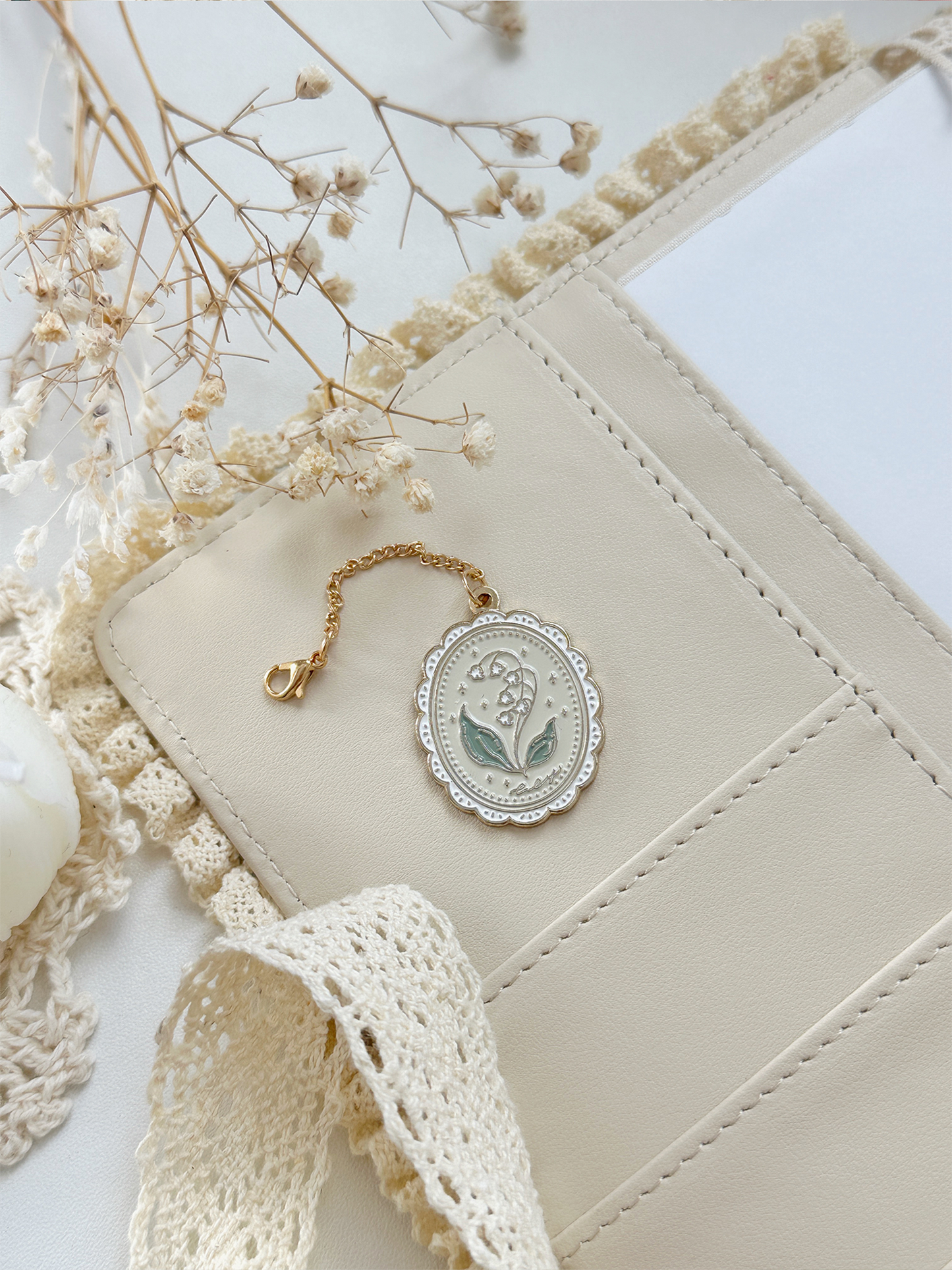 framed lily of the valley enamel keychain